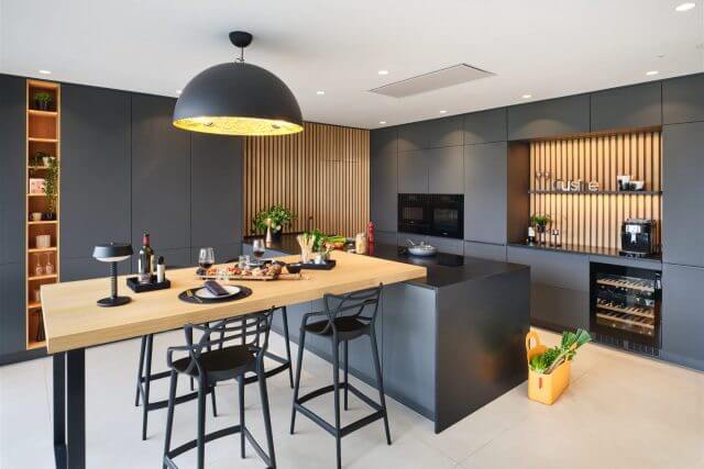 Contemporary German kitchen with wood breakfast bar by Tolle Kitchens