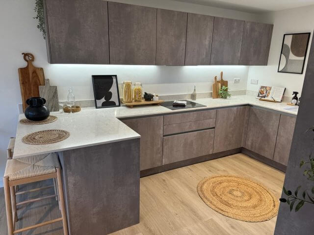 Compact contemporary kitchen with grey cabinetry and light worktops