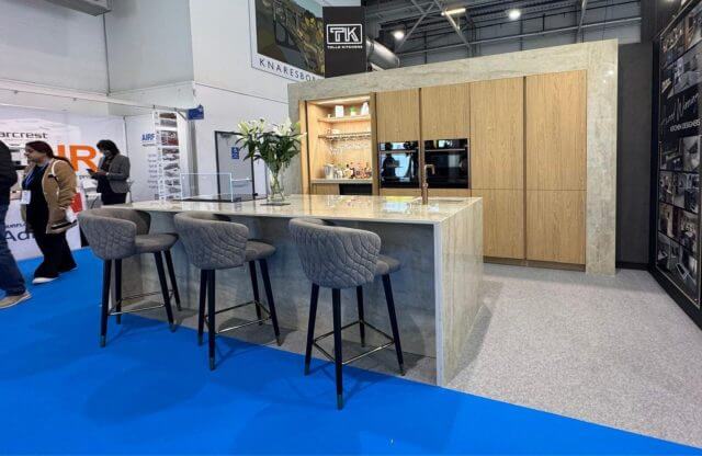 Contemporary kitchen with large stone island and wood wall cabinets