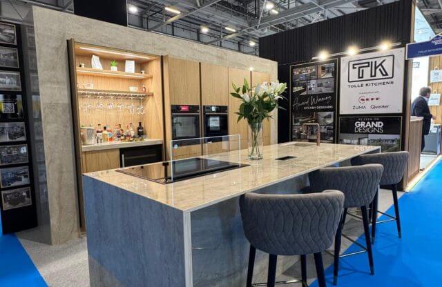 Tolle Kitchens Grand Designs exhibition stand featuring bespoke island with stone worktop and integrated bar area